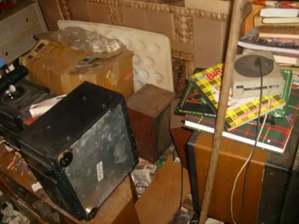 Room filled with bagged rubbish before clearance