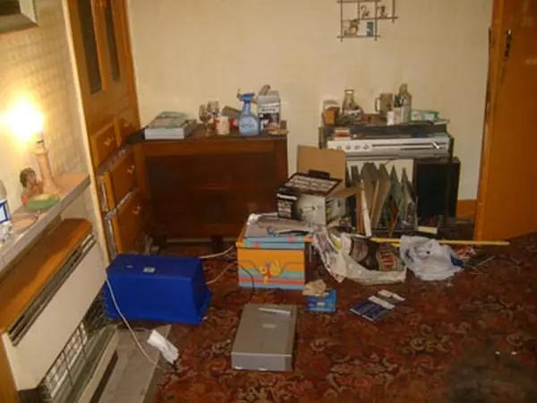 Room filled with bagged rubbish before clearance