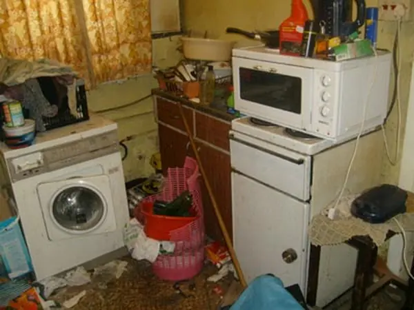Room filled with bagged rubbish before clearance