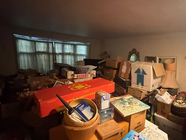 Garage and garden piled with contents before clearance
