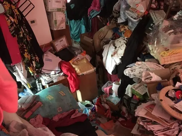 Hoarded kitchen and living rooms before clearance